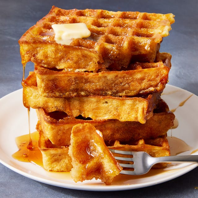 square classic waffles topped with butter and drizzled with maple syrup