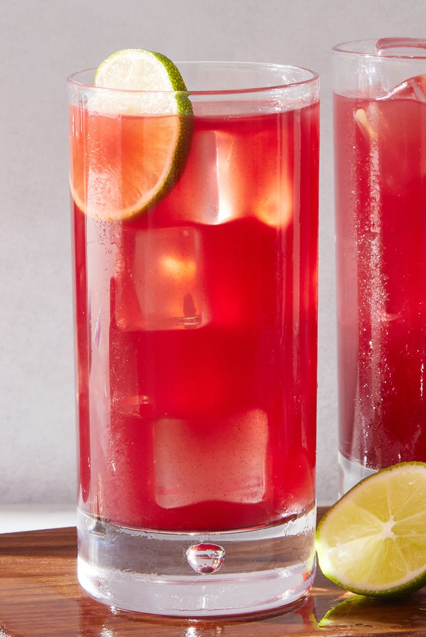 three glasses filled with bay breeze cocktail garnished with lime wedges