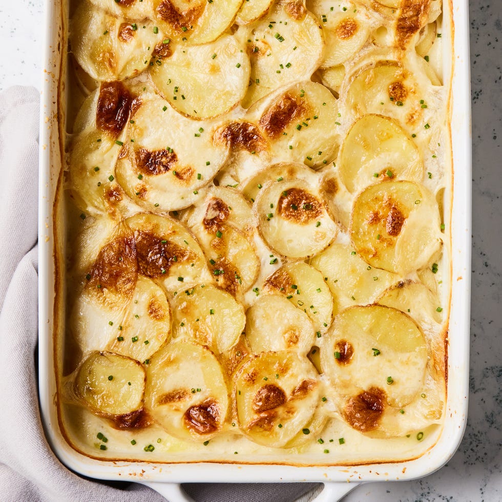scalloped potatoes in a white baking dish
