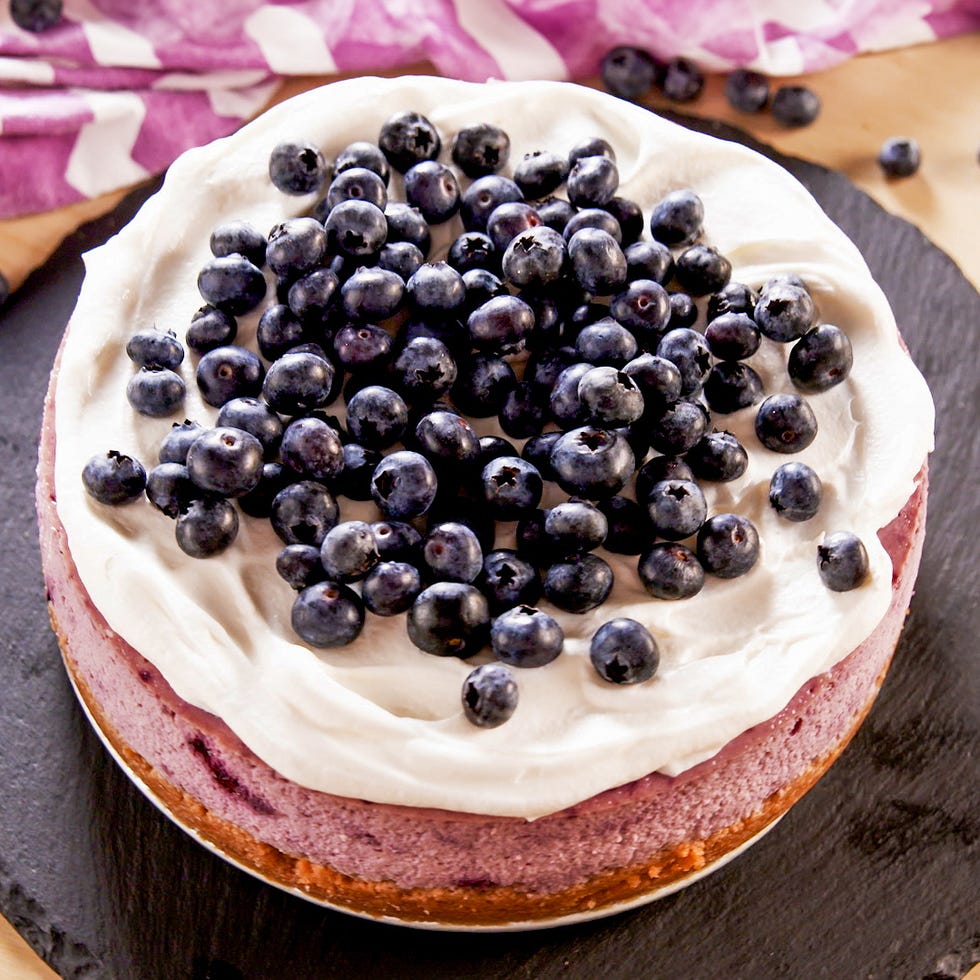 blueberry cheesecake topped with whipped cream and fresh blueberries