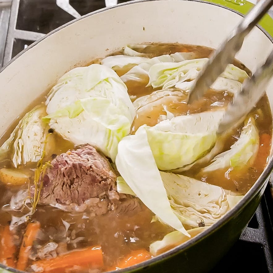 adding cabbage to boiled dinner pot