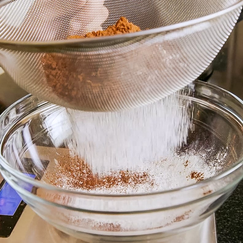 sifting dry ingredients into a bowl