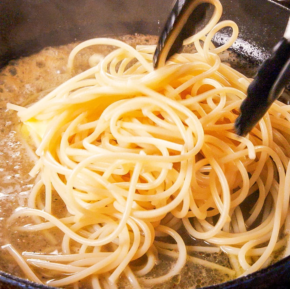 cooking spaghetti noodles in a pot