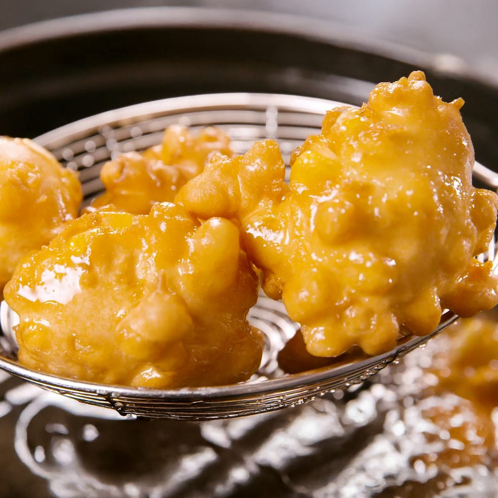 scoops of corn fritters in a spider