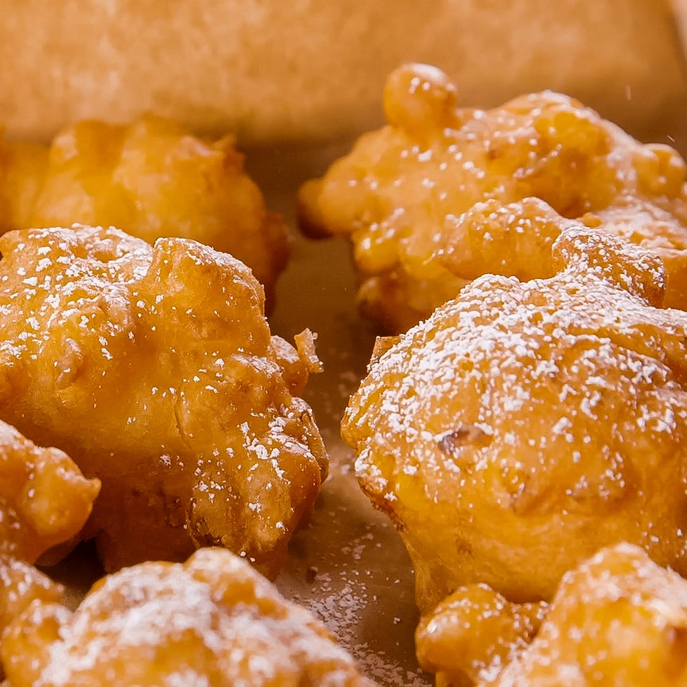 corn fritters sprinkled with confectioners' sugar