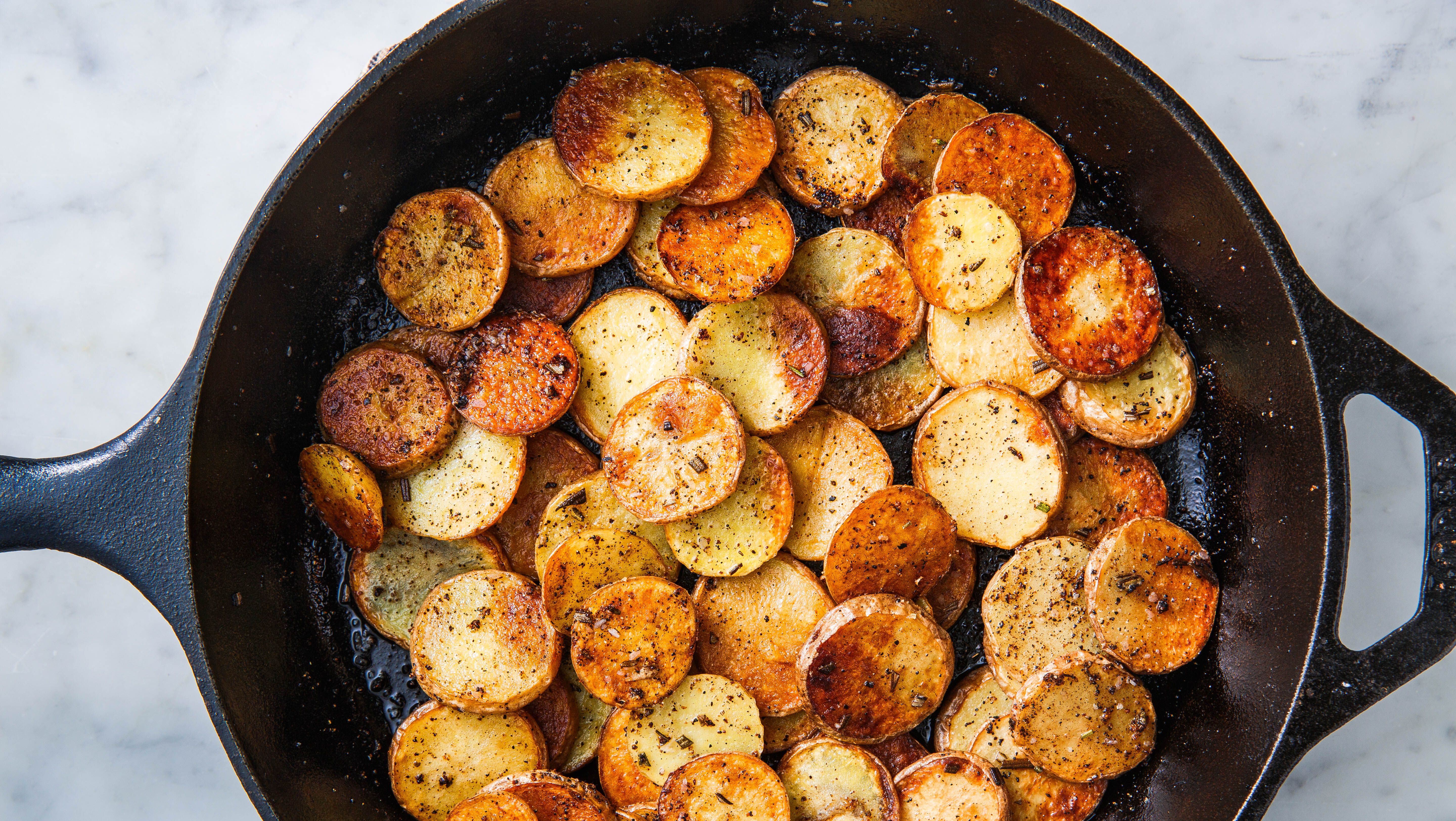 Gold Potatoes With Bacon in a Cast Iron Skillet 