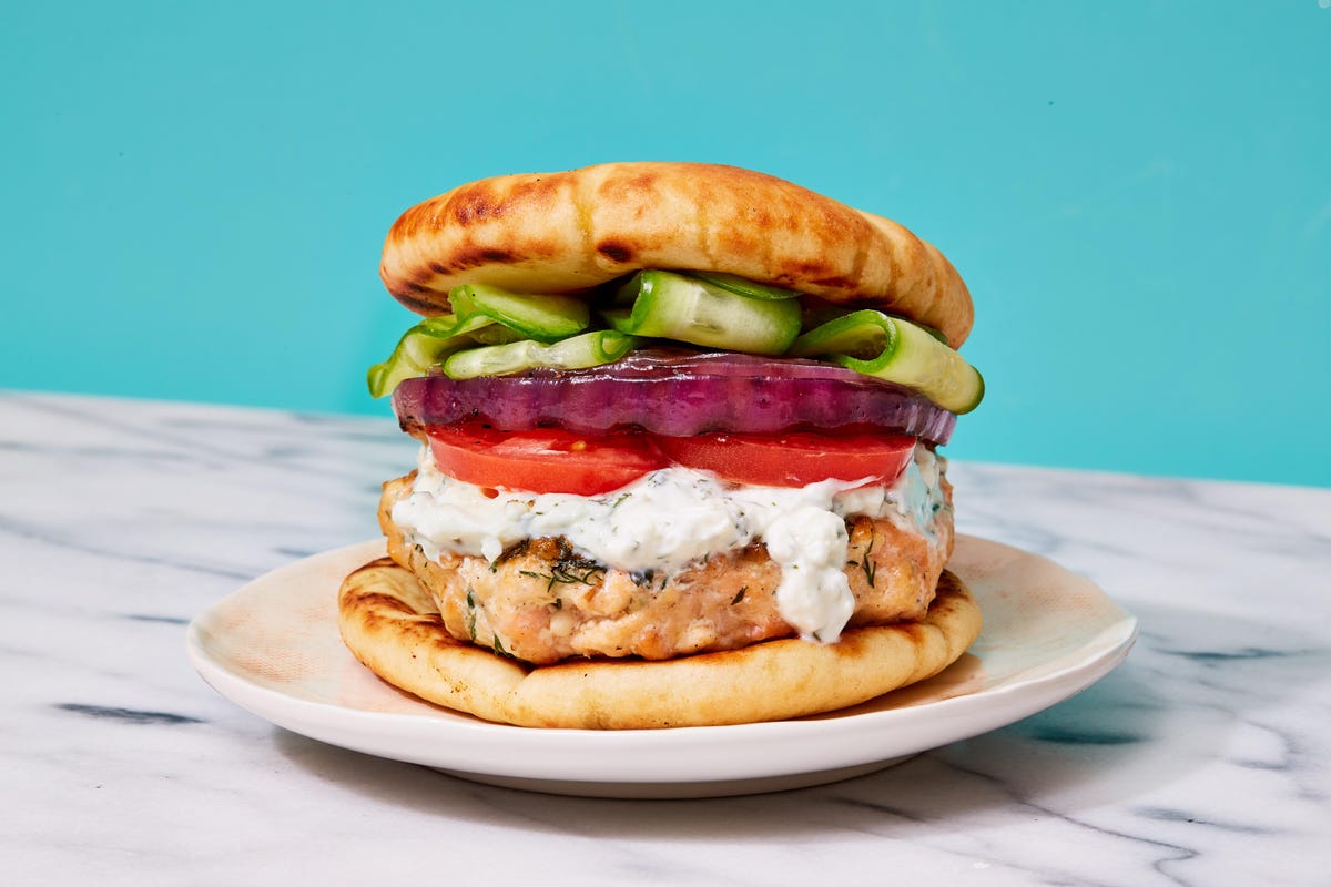 https://hips.hearstapps.com/hmg-prod/images/delish-greek-salmon-burgers-1622231969.jpg?crop=0.670xw:1.00xh;0.171xw,0&resize=1200:*