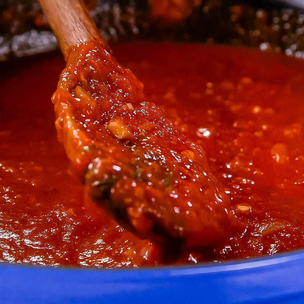 red sauce with a wooden spoon for mixing