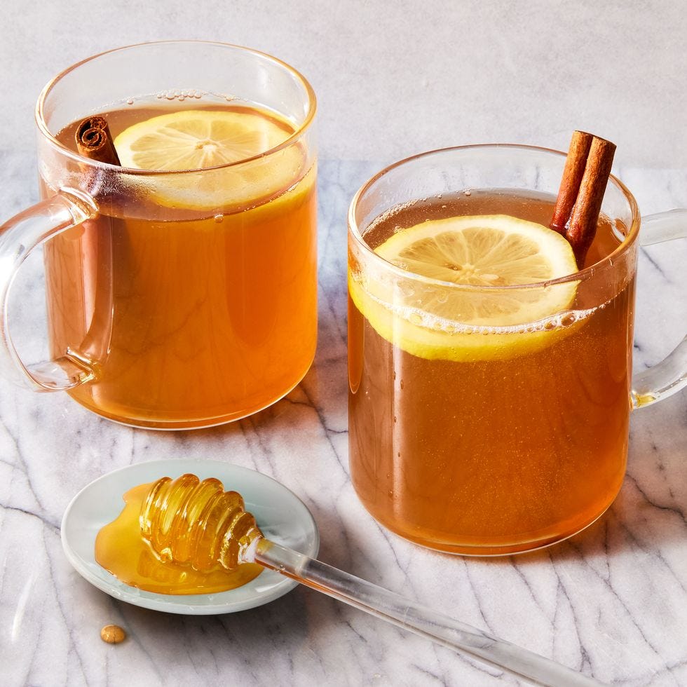 two glasses of liquid with lemons