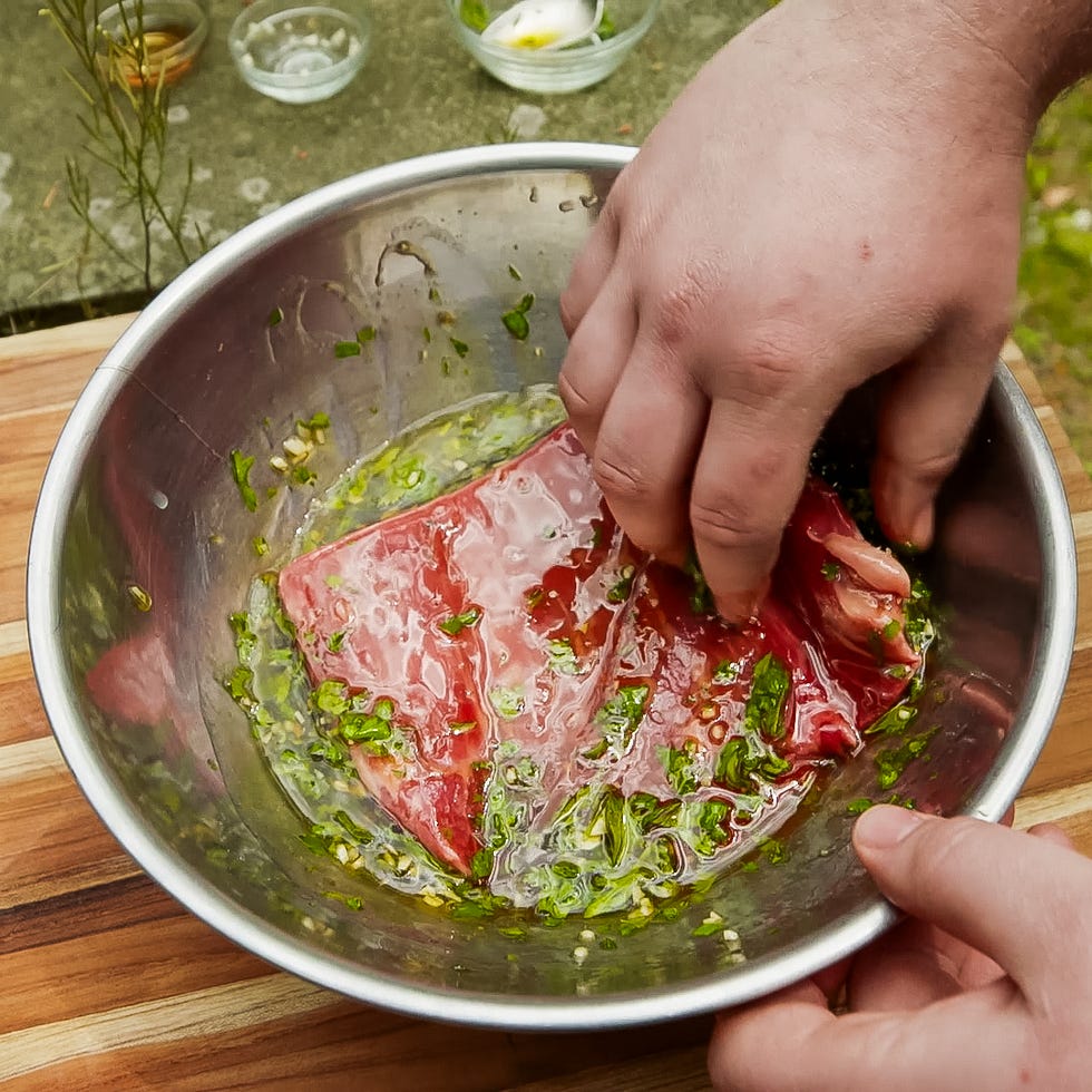 marinating flank steak in a bowl