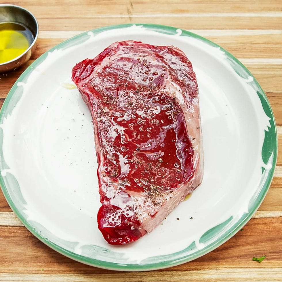 ribeye steak seasoned on a plate