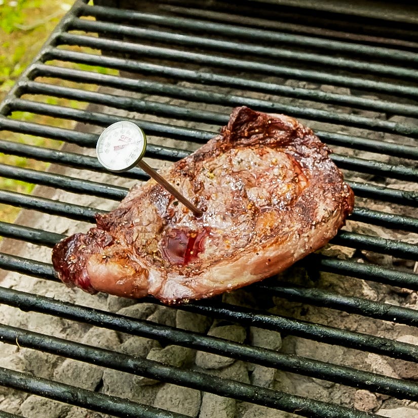 grilled steak with a probe thermometer