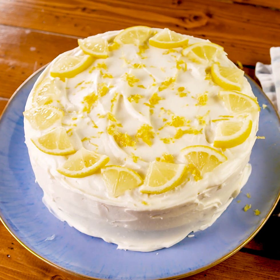 a lemon cake with lemon slices and lemon zest on top