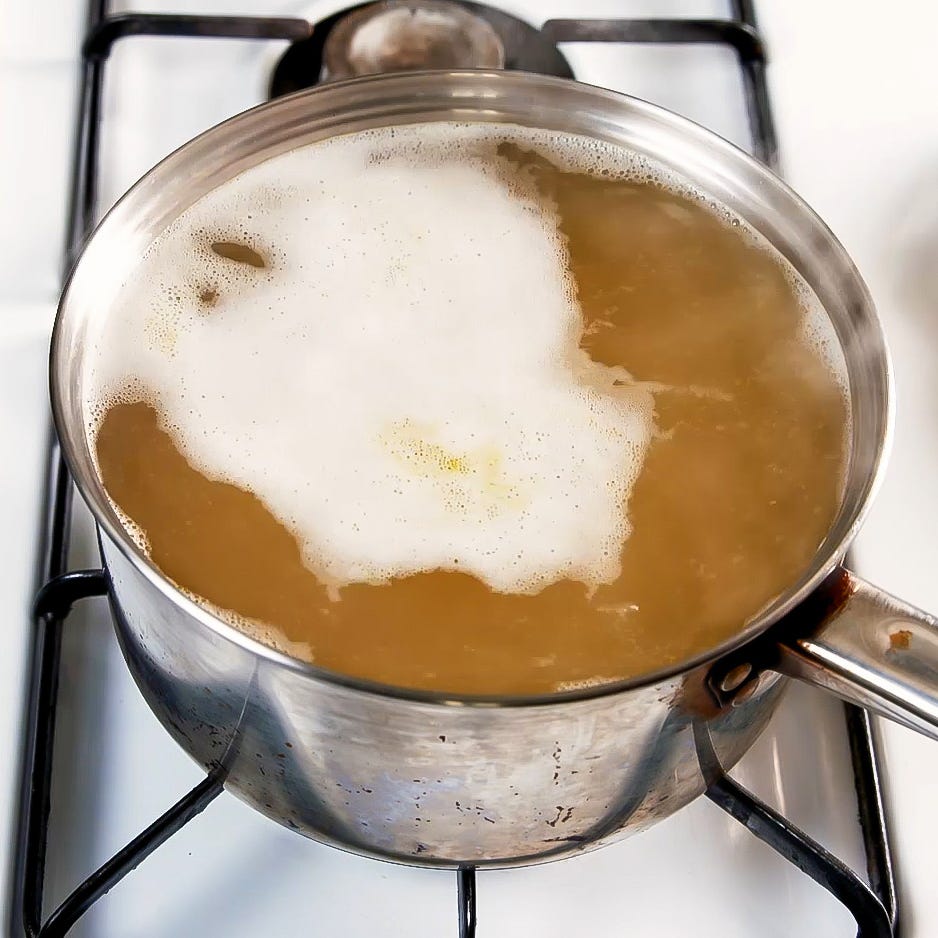 bringing broth to a simmer in a saucepan