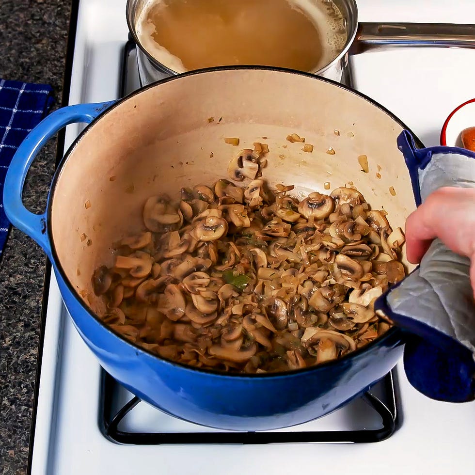 a pot of cooked onions and mushrooms on a stove