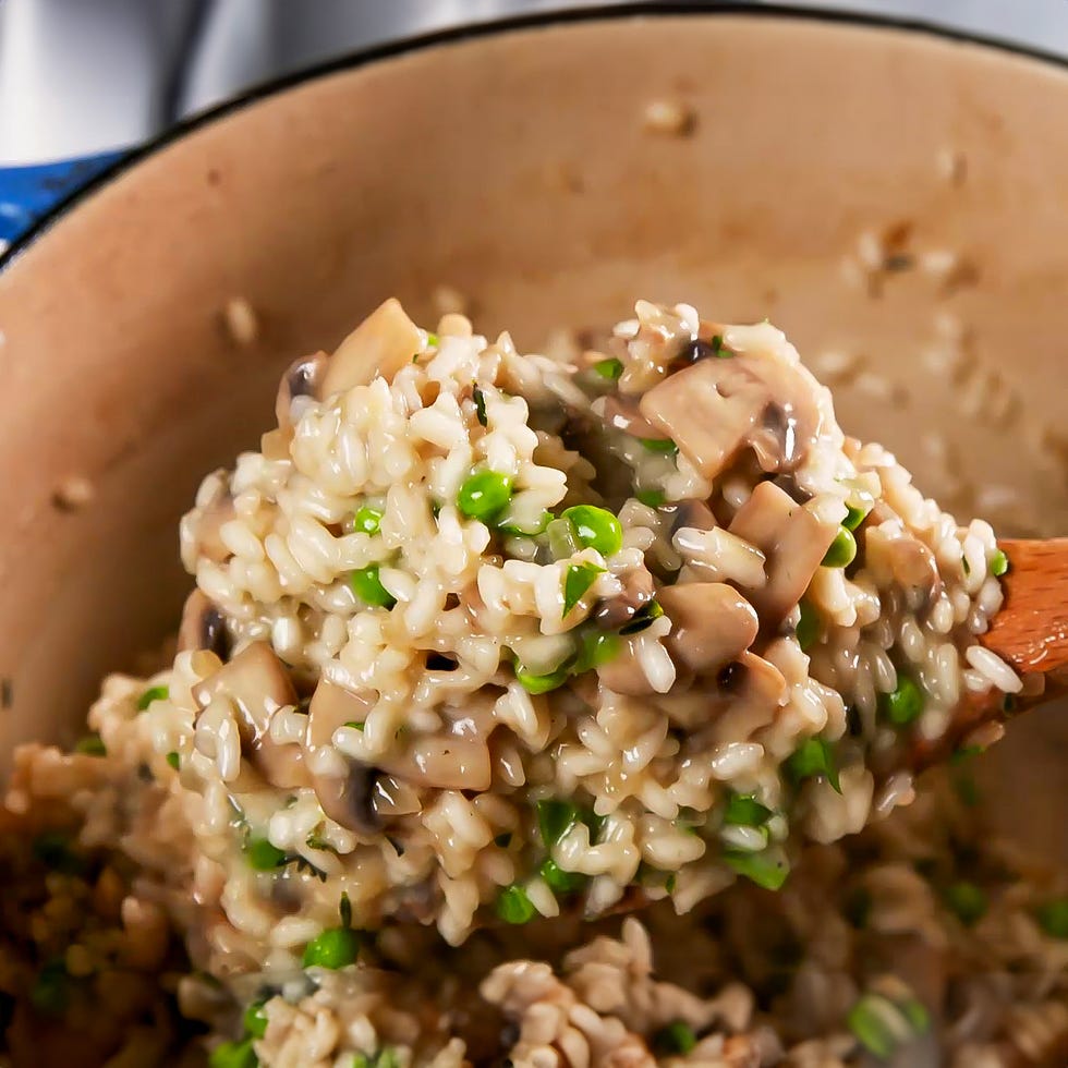 stirring peas into risotto