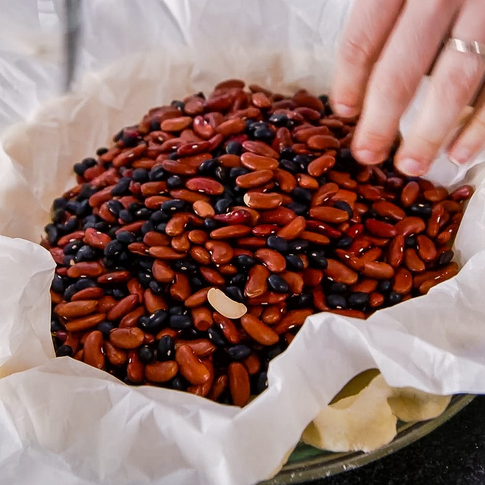 assorted dried beans in a bowl lined with parchment paper