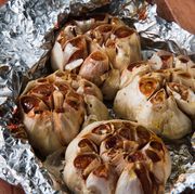 4 cloves of golden roasted garlic partially wrapped in aluminum foil