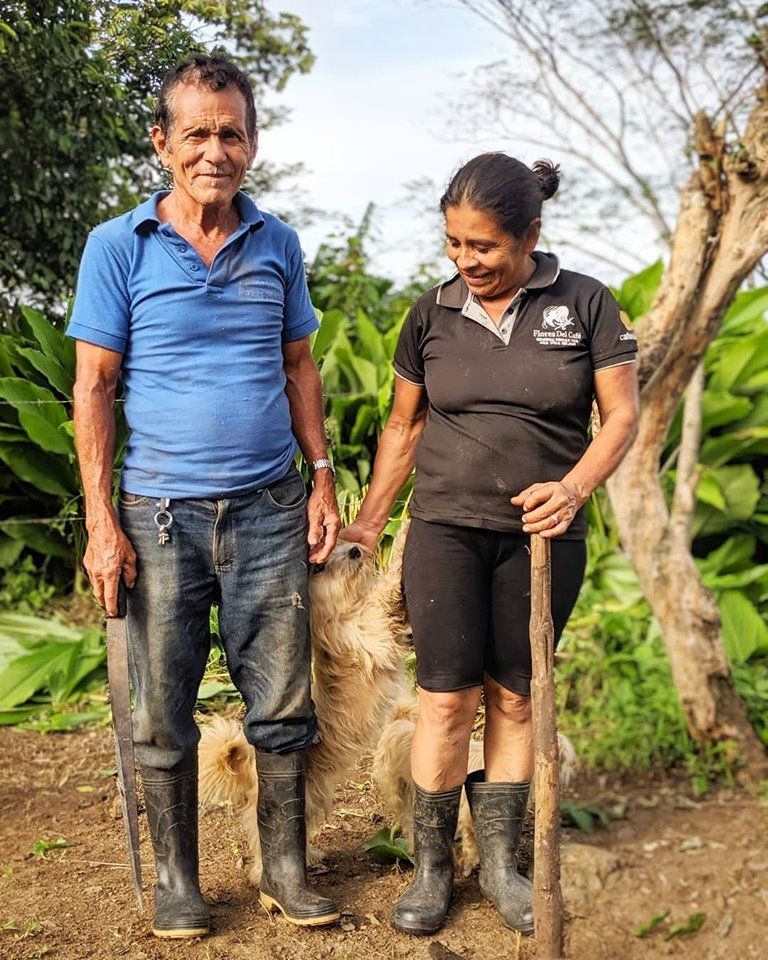 two farmers in nicaragua, playing with their dog