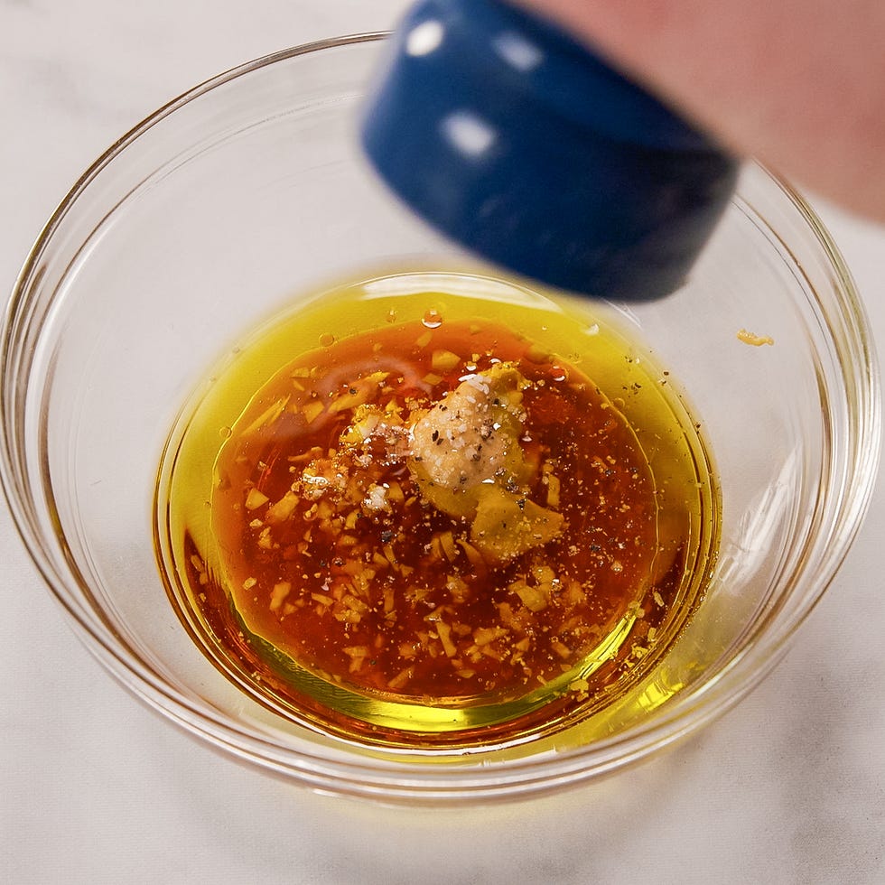 seasoning homemade dressing of oil, vinegar, garlic, mustard