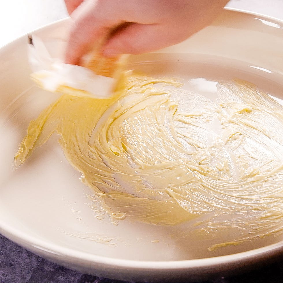 greasing a baking dish with butter