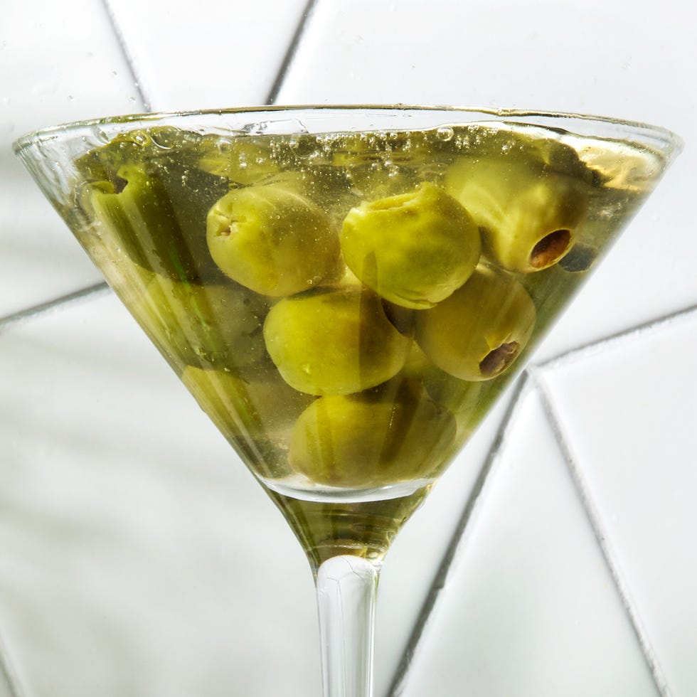 perfect dirty martini with chilled gin, dry vermouth, and olive brine