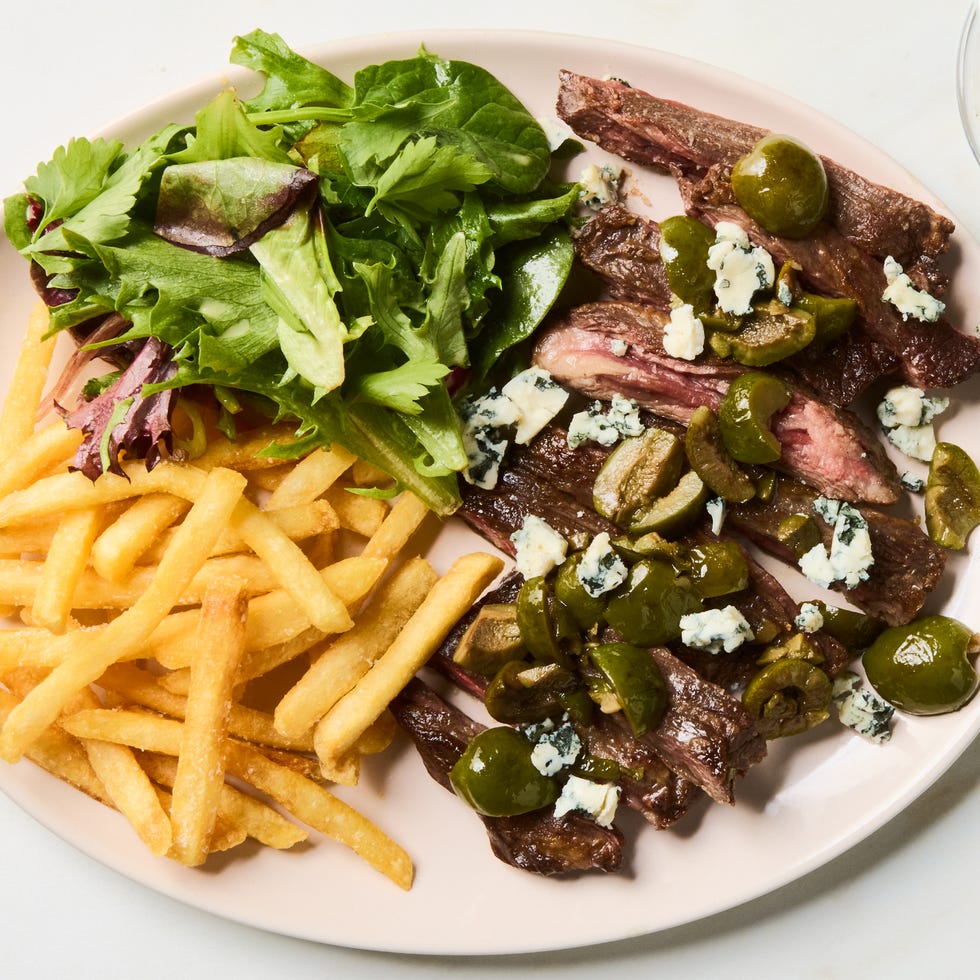 seared skirt steak topped with buttery green olive, gin, and vermouth sauce and served with crispy golden french fries