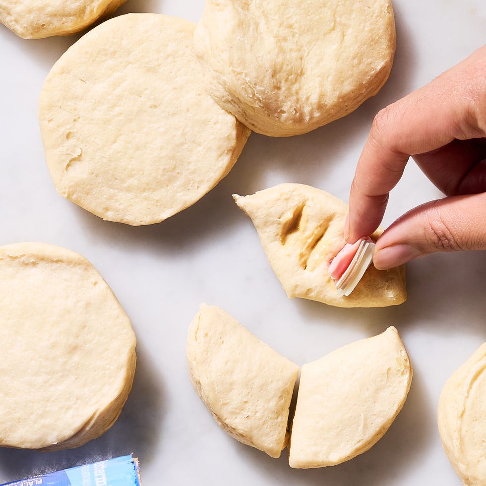 stuffing a hasselbacked biscuit with ham and cheese