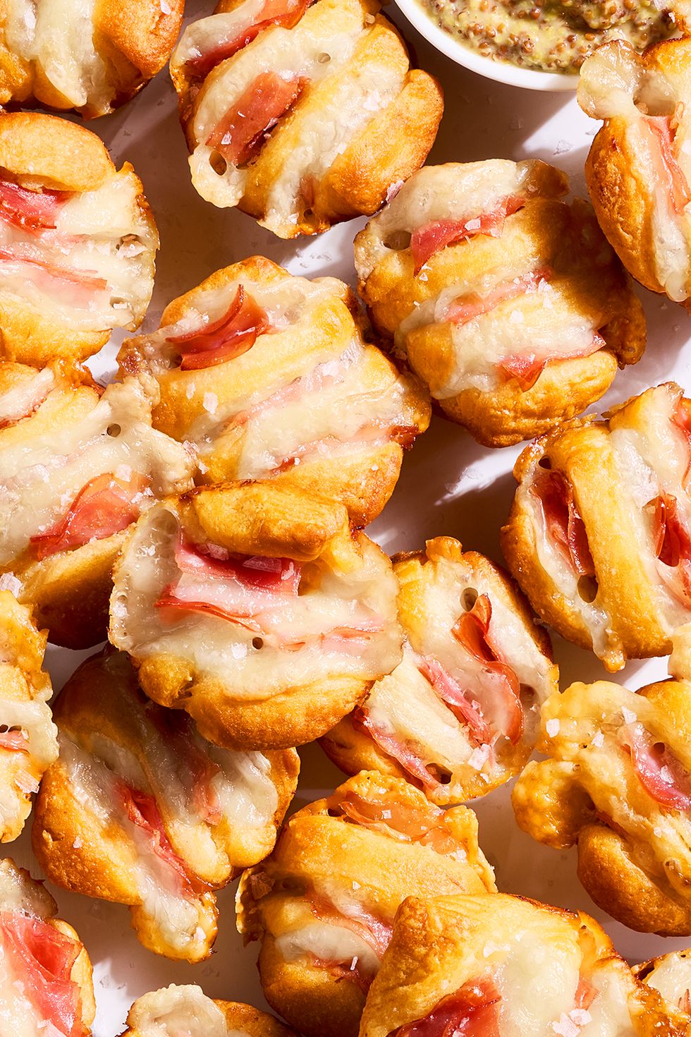ham and swiss hasselback biscuit bites on a tray