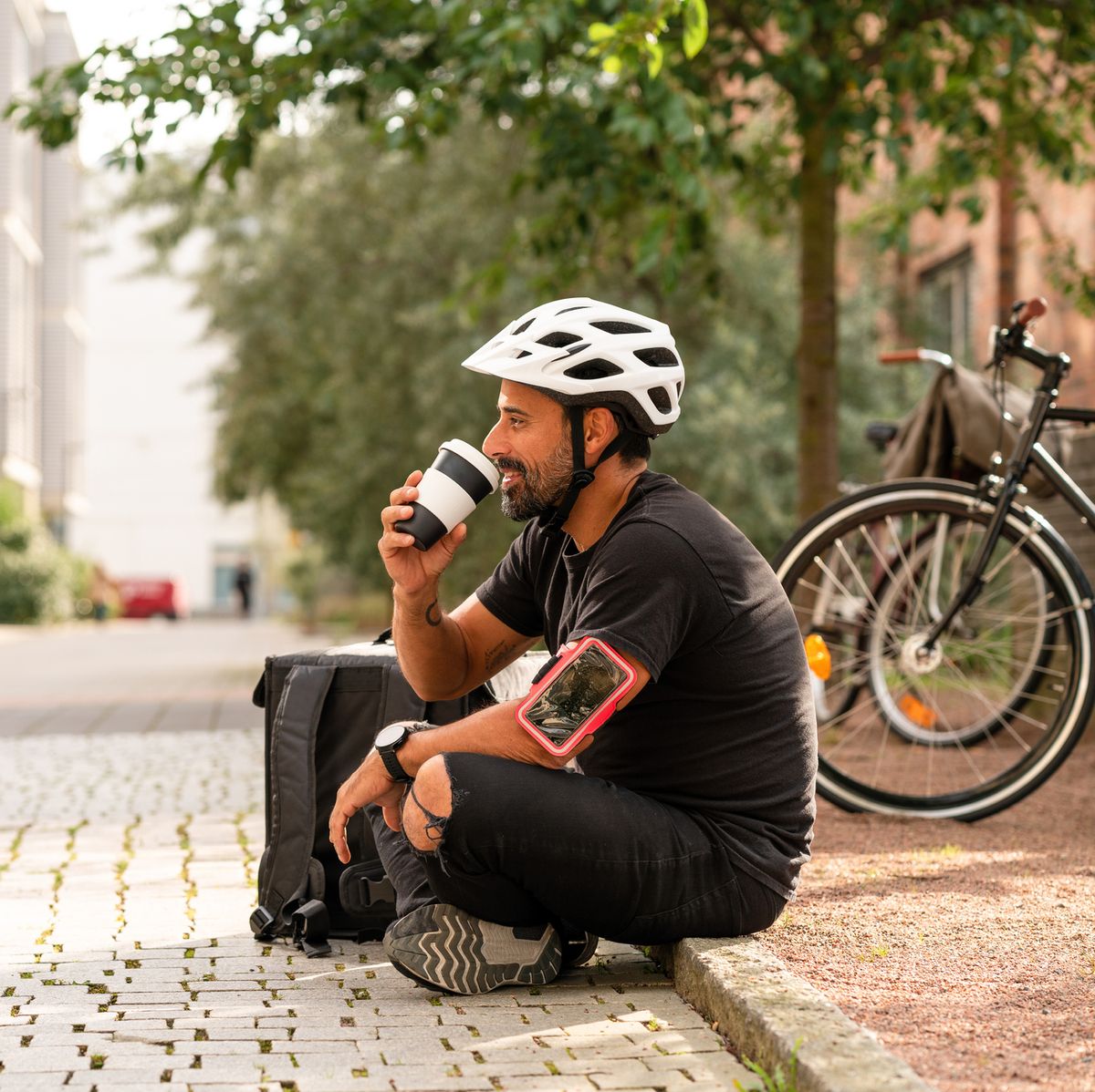 a delivery man is taking a break from riding his bike, black tea healthy aging