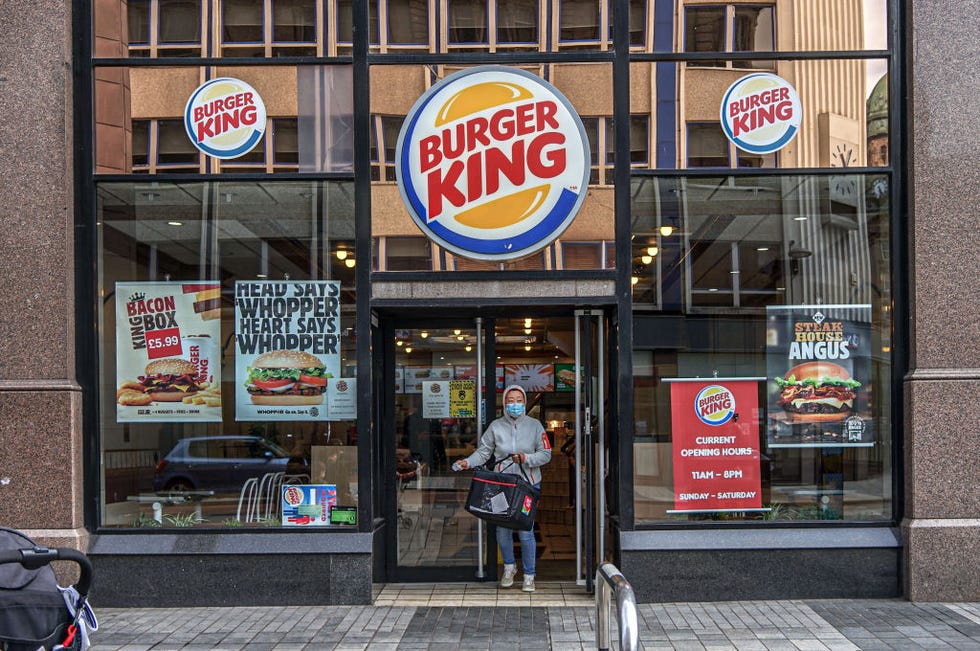 a delivery man wearing a face mask seen leaving burger king
