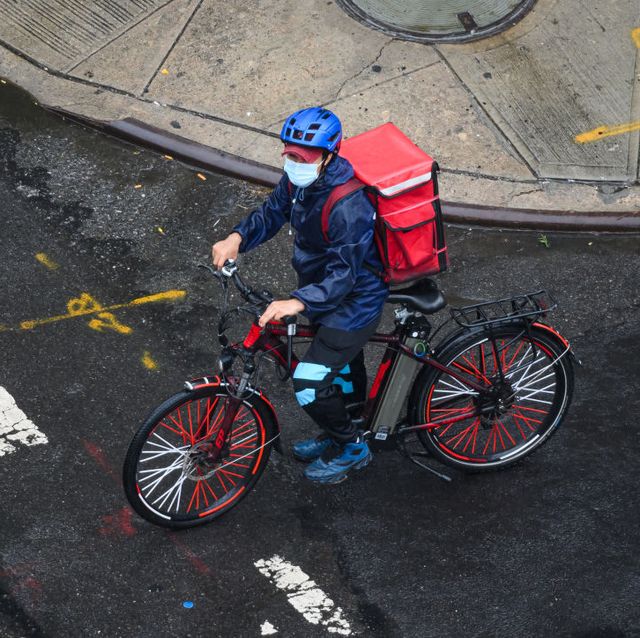 a food delivery cyclist on an e bike in new york city
