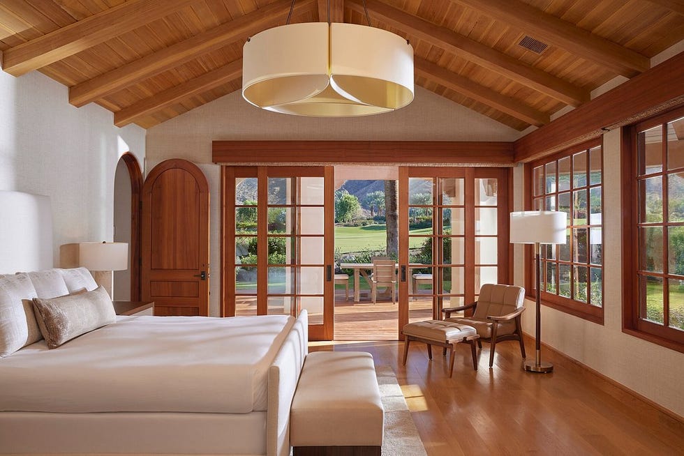 a bedroom with a large glass door