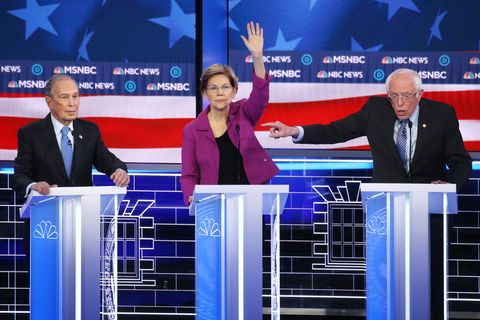 Democratic presidential candidate Sen. Bernie Sanders (I-VT) (R) gestures as Sen. Elizabeth Warren (D-MA) and former New Yor