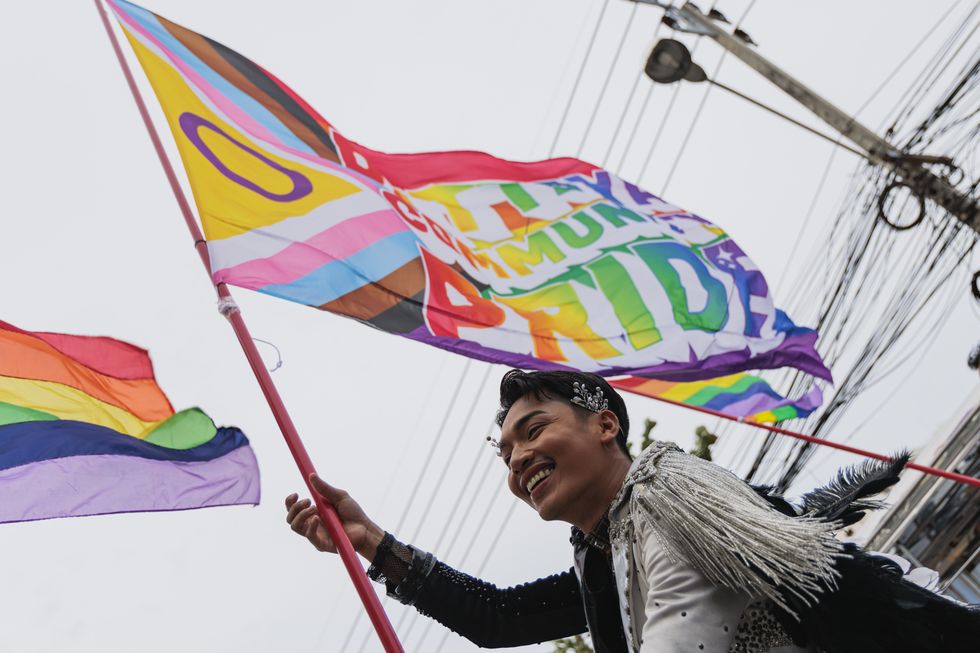 demonstrator seen waving a pride flag during the parade