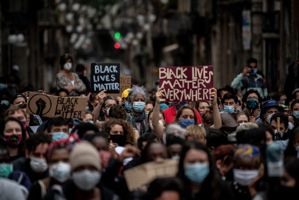 protestor holding up sign that reads 'black lives matter everywhere'