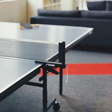 a table with a chair and a couch in the background