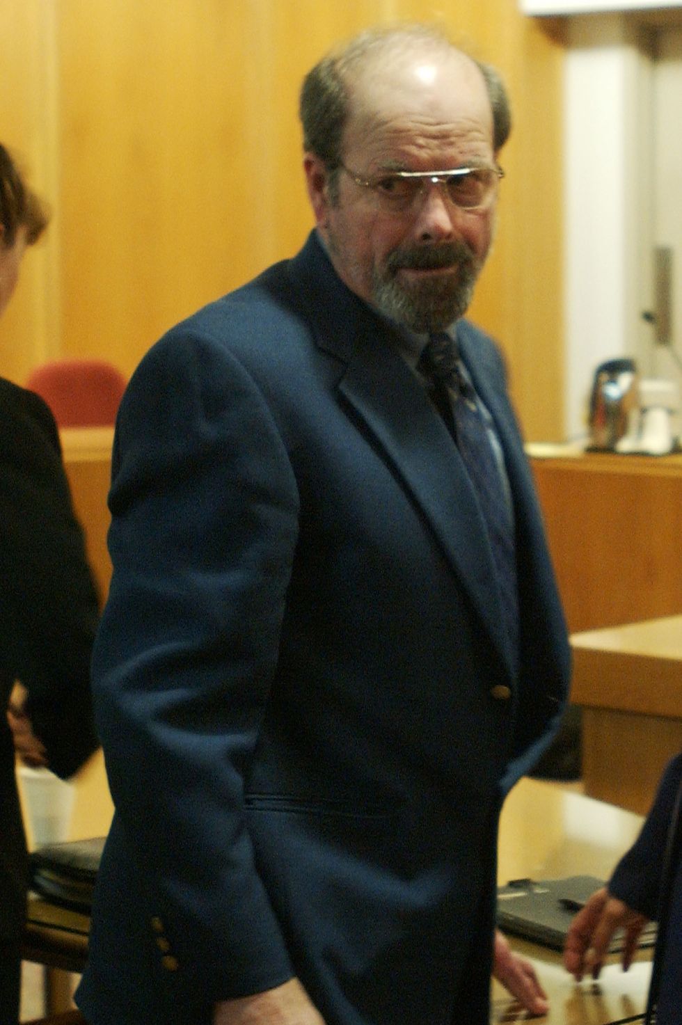 btk killer dennis rader turning back and looking to his right as he leaves a courtroom