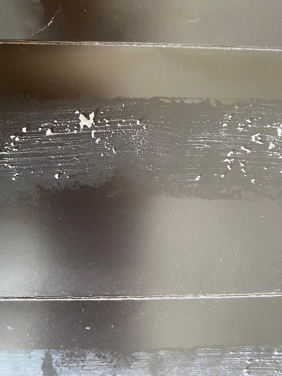 a clumpy swipe of deodorant on a black cardboard surface