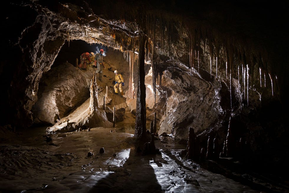 cavers descend into a grotto at the lowest levels of the veryovkina system during the flood water was up to the ceiling