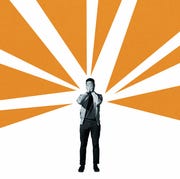 Depressed man covering face amidst orange rays depressed man covering face amidst orange rays