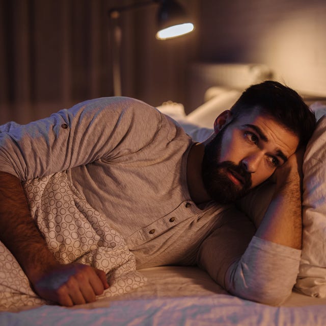 depressed man lying in his bed and feeling bad