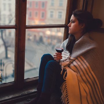 how to treat seasonal affective disorder, depressed woman looking through the window