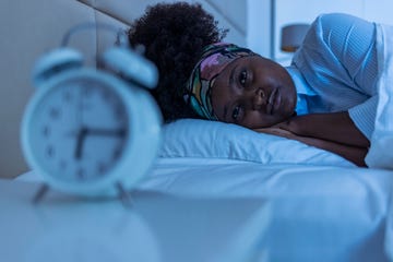 depressed young woman lying in bed and feeeling upset after quarrel with her boylfriend in bed at home