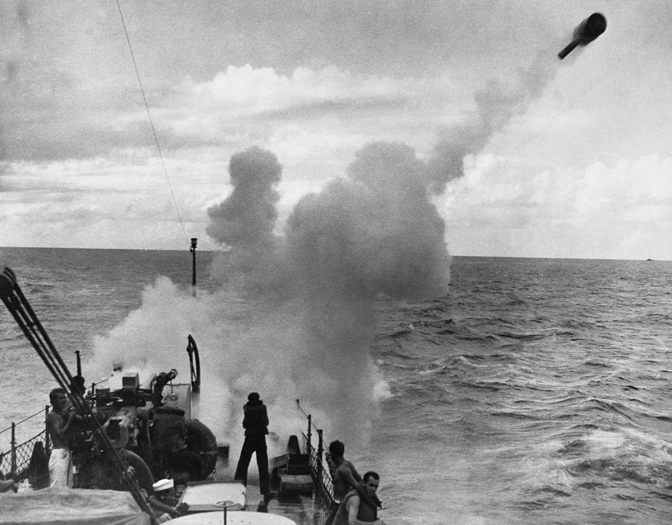 sailors launch a depth charge at an enemy submarine during world war two