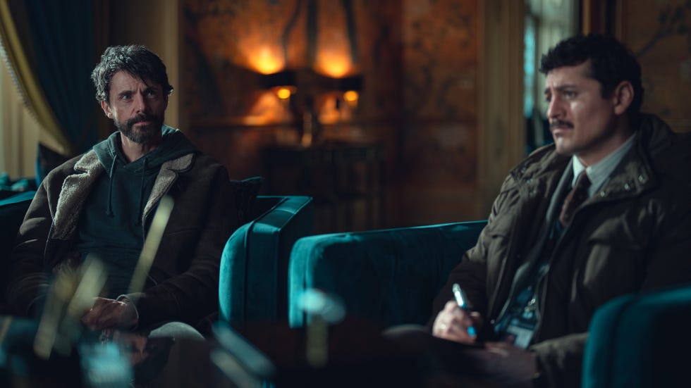 two individuals engaged in a conversation in a wellfurnished room