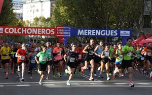 aficionados del real madrid y del atlético de madrid, junto al estadio santiago bernabéu, en la salida de la carrera popular derbid de las aficiones