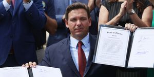 miami, florida   june 07 florida gov ron desantis holds up two bills he signed at the florida national guard robert a ballard armory on june 07, 2021 in miami, florida the governor signed the bills to combat foreign influence and corporate espionage in florida from governments like china photo by joe raedlegetty images