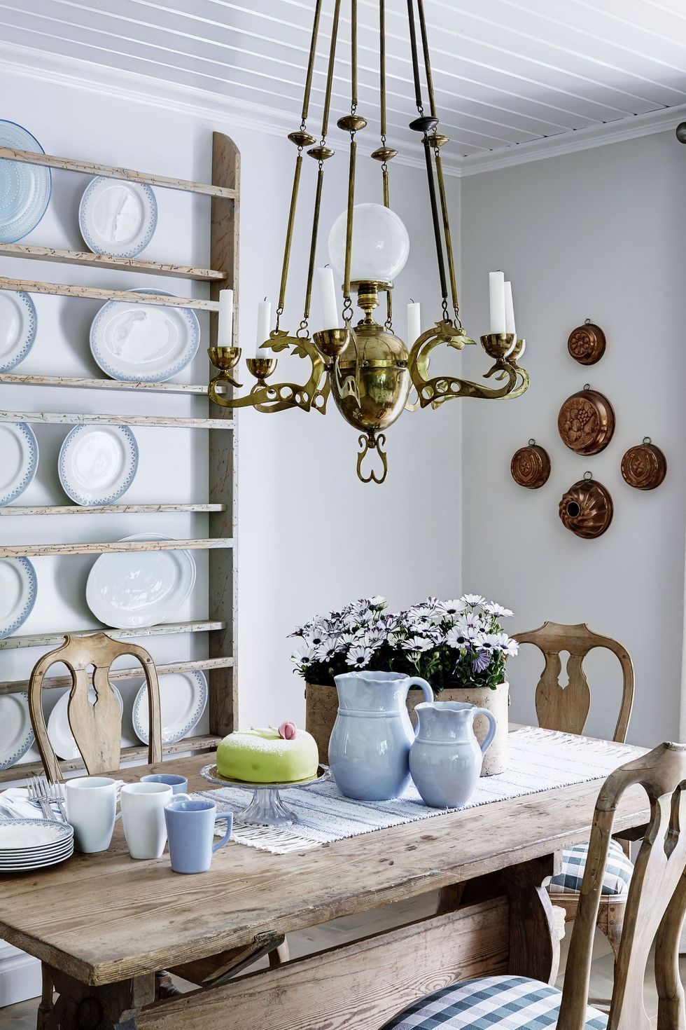 a dining table with white plates and white chinaware