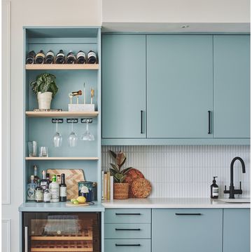 a reading nook in a green living room a blue kitchen with bar shelving with decorative accessories